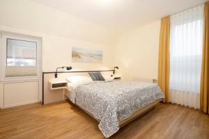 Postel nebo postele na pokoji v ubytování Lindenbuschen 2 Wohnung 5