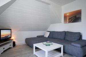 a living room with a couch and a table at Seestraße 30a In der Mühle in Dahme