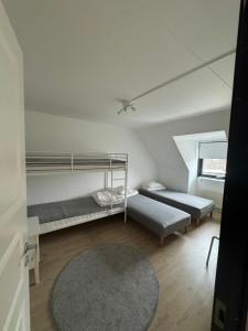 a room with two bunk beds and a rug at Cozy House in Oxie Malmö in Oxie