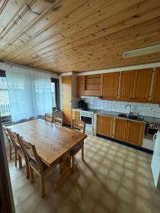a large kitchen with a wooden table and chairs at Cozy House in Oxie Malmö in Oxie