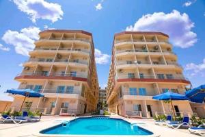 a hotel with a swimming pool in front of a building at Casablanca Beach for families only in Hurghada