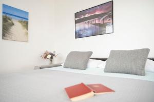 two beds in a hotel room with at Strandhotel Scharbeutz Kleine Krabbe in Scharbeutz +20 photos