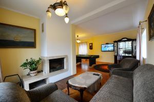 a living room with couches and a fireplace at Rambyno apartamentai in Klaipėda