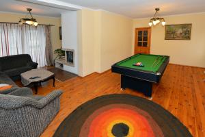 a living room with a pool table in it at Rambyno apartamentai in Klaipėda