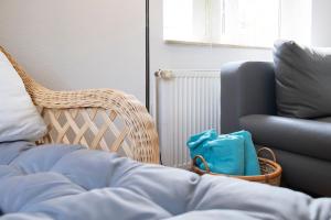 a bedroom with a bed and a chair at Haus Sonnenberg in Timmendorfer Strand +41 photos