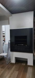 a fireplace in a living room with a white and black at Ed. Praia de Palmas SC in Governador Celso Ramos