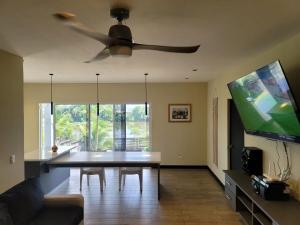 a living room with a table and a ceiling fan at Casa Bella Vista in Bluefields