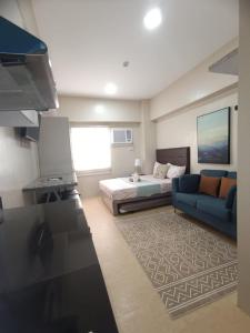 a living room with a bed and a couch at Cebu Stay Rental - Sunvida Tower Residences in Cebu City