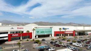 a parking lot in front of a shopping mall at Cozy full condo with pool and close to the beach in Cabo San Lucas