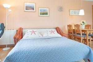 a bedroom with a blue bed with stars on it at Am Hafen 2d Inselsonne 2 in Orth +27 photos