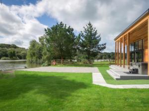 a house on the water with green grass at Silver Birch in Winkleigh
