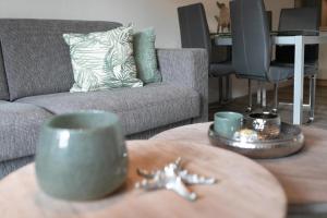 a living room with a coffee table and a couch at Seepark Strandglück in Scharbeutz