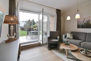 a living room with a couch and a table at Seepark Strandglück in Scharbeutz