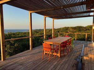 a wooden deck with a table and chairs on it at Villa Achado in Santa Maria +19 photos