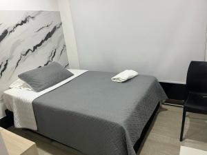 a bedroom with a bed and a chair in it at DUSANO BOUTIQUE HOTEL in Santa Marta