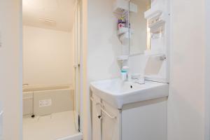 a white bathroom with a sink and a shower at シマエナガ札幌 in Sapporo +37 photos