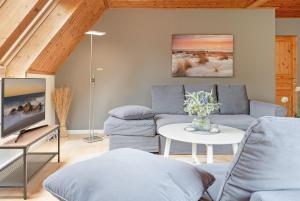 a living room with a couch and a table at Steenkamp 32 Aus-Zeit in Timmendorfer Strand +29 photos