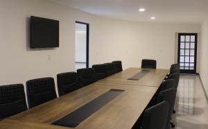 a large conference room with a long table and chairs at Hangar Inn TJ - Aeropuerto in Tijuana