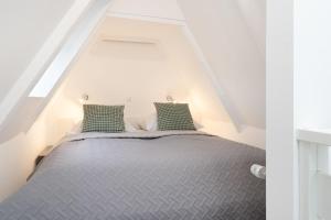 Ένα ή περισσότερα κρεβάτια σε δωμάτιο στο Lüttge Hus