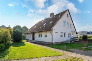 a white house with a brown roof at Blankwasserweg 16- Sonnenseite in Grömitz