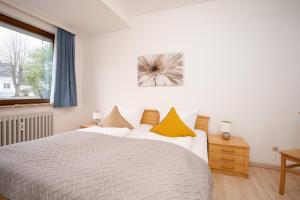 Postel nebo postele na pokoji v ubytování Haus Seebrise- Wohnung 7
