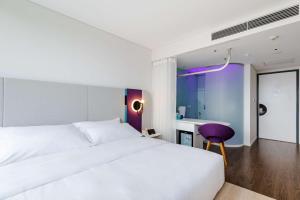 Voodi või voodid majutusasutuse Tru by Hilton Hanoi Station toas