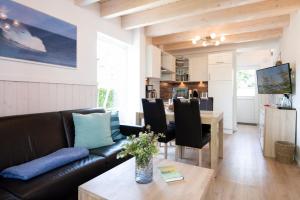 a living room with a couch and a table at Seepark Süssau Ferienhaus Seehund 1 in Süssau