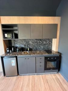 a kitchen with a sink and a counter top at Edificio Pantera - Soñar es crear in San Martín de los Andes +19 photos