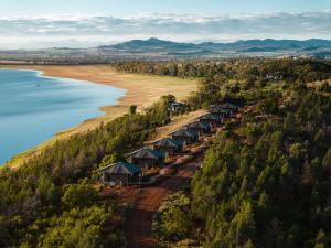 an aerial view of a beach with a row of tents at Wilderluxe Lake Keepit in Keepit