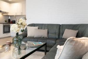 a living room with a couch and a glass table at Sol Mare Baltic-Stern in Kellenhusen