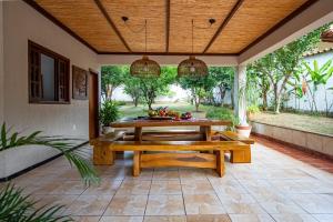 a patio with a wooden table with fruit on it at Maravilhosa casa com piscina em Lagoa Santa in Lagoa Santa