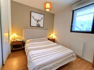 a bedroom with a bed with a deer picture on the wall at T2 cabine pour 4 pers, balcon, parking – Saint-Lary-Soulan - FR-1-457-379 in Saint-Lary-Soulan