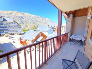 a balcony with a table and chairs and a mountain at T2 cabine pour 4 pers, balcon, parking – Saint-Lary-Soulan - FR-1-457-379 in Saint-Lary-Soulan