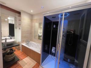 a man taking a picture of a shower in a bathroom at Appartement moderne au centre d'Épinal, 2-4 pers - FR-1-589-807 in Épinal