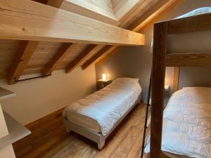 two bunk beds in a room with wooden ceilings at Duplex de luxe 96m² - Terrasse - Ski au pied - 9 Pers. - FR-1-445-221 in Montgenèvre