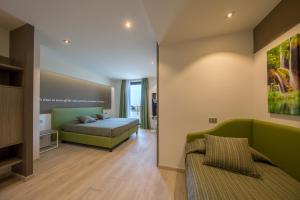 a bedroom with a bed and a couch at Hotel Ideal in Sirmione