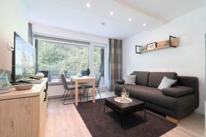 a living room with a couch and a table at Haus Meeresgruß Ostseebrise in Grömitz