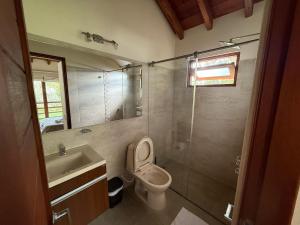 a bathroom with a toilet and a sink and a shower at Apartasuites Las Marías in Villa de Leyva +87 photos