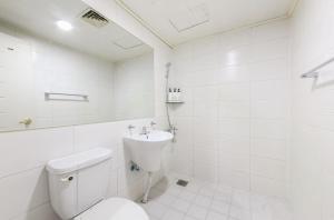 a white bathroom with a toilet and a sink at Vatican Hotel Sangmu in Gwangju +24 photos