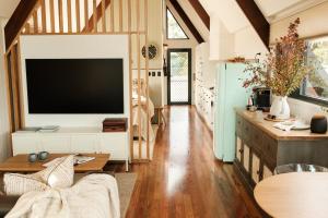 a living room with a large flat screen tv at Skyfarm Retreat in Cradoc