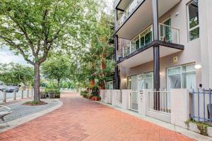 a brick sidewalk in front of a building at Lakeview Family Retreat Canberra Cozy Townhouse in Gungahlin