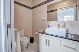 a bathroom with a toilet and a sink and a mirror at Lakeview Family Retreat Canberra Cozy Townhouse in Gungahlin +21 photos