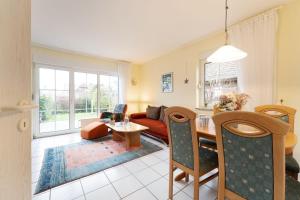 a living room with a couch and a table at Ferienhaus 17a in Kellenhusen