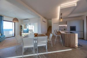 a kitchen and living room with a table and chairs at Villa La Bella Vita in Petrosino