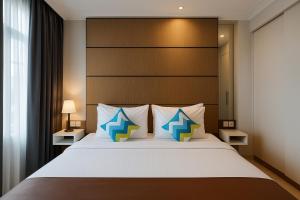 A bed or beds in a room at The Bellezza Hotel Suites