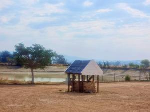 a small building with a blue roof in a field at Val Mor country house in Paarl