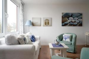 a living room with a couch and two chairs at Dorfring 36 Albatros in Stein