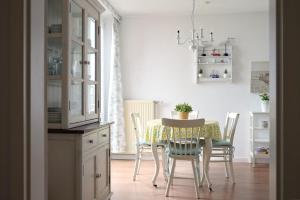 a dining room with a table and chairs in a kitchen at Dorfring 36 Albatros in Stein +9 photos