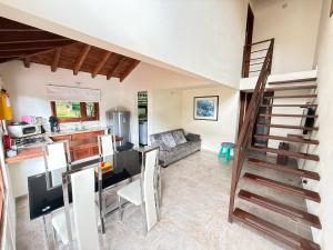 a kitchen and a living room with a spiral staircase at Apartasuites Las Marías in Villa de Leyva