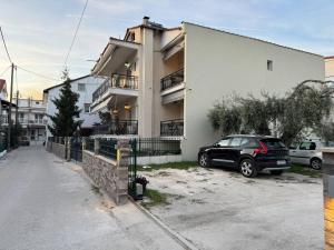 a black car parked in front of a building at Elata Apartments in Limenas